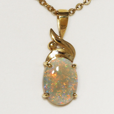 9k Yellow Gold Pendant with a SOLID SEMI BLACK OPAL Bright Pinfire pattern. Orange, yellow and green sparkle through a clear body